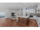 Open-concept kitchen with a center island flowing into the living area, great for entertaining at 2511 Range Overlook Xing, Apex, NC 27523