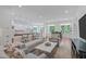Bright and airy living space featuring hardwood floors, comfortable seating, and an open layout at 2511 Range Overlook Xing, Apex, NC 27523