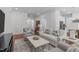 Open living room with hardwood floors, comfortable seating, and bright natural light at 2511 Range Overlook Xing, Apex, NC 27523