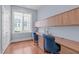 Home office featuring custom built-ins, wood floors, and a bright window with backyard views at 2511 Range Overlook Xing, Apex, NC 27523