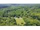 Aerial view of the neighborhood featuring a beautiful tree canopy, a well-manicured lawn, and quaint homes at 2613 Sweet Gum Dr, Hillsborough, NC 27278