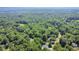 Aerial view of a neighborhood surrounded by dense, mature trees and greenery at 2613 Sweet Gum Dr, Hillsborough, NC 27278