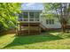 Spacious backyard with a deck, stairs, and lush green grass, perfect for outdoor enjoyment at 2613 Sweet Gum Dr, Hillsborough, NC 27278