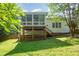 Spacious backyard with a deck, stairs, and lush green grass, perfect for outdoor enjoyment at 2613 Sweet Gum Dr, Hillsborough, NC 27278