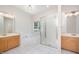 Bright bathroom with double vanities, tub, and glass-enclosed shower at 2613 Sweet Gum Dr, Hillsborough, NC 27278