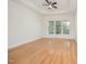 Spacious bedroom featuring gleaming hardwood floors, large windows, and a modern ceiling fan at 2613 Sweet Gum Dr, Hillsborough, NC 27278