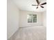 Empty bedroom featuring neutral walls, carpet, a ceiling fan, and a large window at 2613 Sweet Gum Dr, Hillsborough, NC 27278