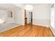 Elegant dining room with hardwood floors, a modern chandelier, and an archway leading to the living room at 2613 Sweet Gum Dr, Hillsborough, NC 27278