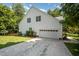 White home exterior featuring a two-car garage and a concrete driveway at 2613 Sweet Gum Dr, Hillsborough, NC 27278