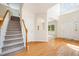 Foyer with hardwood floors and staircase in naturally lit open concept home at 2613 Sweet Gum Dr, Hillsborough, NC 27278