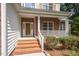 Inviting front porch with brick steps and white railings, leading to the front door of the home at 2613 Sweet Gum Dr, Hillsborough, NC 27278