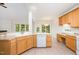 Spacious kitchen with light wood cabinets, tile flooring, and an open layout to the breakfast area at 2613 Sweet Gum Dr, Hillsborough, NC 27278