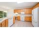 Well-lit kitchen featuring light wood cabinets, modern appliances, and ample counter space at 2613 Sweet Gum Dr, Hillsborough, NC 27278