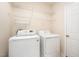 Bright laundry room with washer, dryer and shelving for storage at 2613 Sweet Gum Dr, Hillsborough, NC 27278