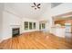 Open concept; living room with fireplace and hardwood floors open to the kitchen area at 2613 Sweet Gum Dr, Hillsborough, NC 27278