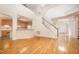 Open floor plan with hardwood floors, fireplace, view to staircase and kitchen at 2613 Sweet Gum Dr, Hillsborough, NC 27278