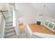 Open concept view from stairs to living room with fireplace and many windows at 2613 Sweet Gum Dr, Hillsborough, NC 27278