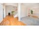 Bright living room features gleaming hardwood floors, a fireplace, and an open staircase to the upper level at 2613 Sweet Gum Dr, Hillsborough, NC 27278
