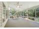 Bright sunroom featuring a ceiling fan and several windows overlooking a wooded area at 2613 Sweet Gum Dr, Hillsborough, NC 27278
