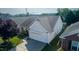 An elevated view of the home's roof, two-car garage, and backyard at 326 Slate Dr, Gibsonville, NC 27249