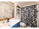 Stylish bathroom featuring a blue vanity, patterned shower curtain, and a framed mirror at 326 Slate Dr, Gibsonville, NC 27249