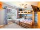 Spacious bedroom featuring a custom-built bunk bed, ceiling fan and a large window overlooking the front yard at 326 Slate Dr, Gibsonville, NC 27249