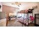 Cozy bedroom with bunk bed, neutral walls and carpet, large window for natural light, and a reptile enclosure at 326 Slate Dr, Gibsonville, NC 27249