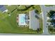 Aerial view of the community pool, parking, and surrounding neighborhood at 326 Slate Dr, Gibsonville, NC 27249