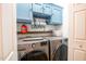 Well-organized laundry room with blue cabinets above stainless steel washer and dryer appliances at 326 Slate Dr, Gibsonville, NC 27249