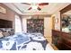 Main bedroom with trey ceilings, large bed and a bookcase with decorative items at 326 Slate Dr, Gibsonville, NC 27249