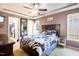 Comfortable main bedroom featuring a tray ceiling, a large bed, and a walk-in closet at 326 Slate Dr, Gibsonville, NC 27249