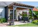 Charming outdoor patio area with pergola, comfortable seating, and lush greenery at 326 Slate Dr, Gibsonville, NC 27249