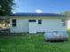 Backyard view of the home showcasing the siding, a small propane tank, and the grassy lawn at 331 E Lillington St, Angier, NC 27501