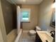 Updated bathroom featuring tiled floors, a modern vanity, and a shower with bathtub at 331 E Lillington St, Angier, NC 27501