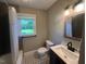 Updated bathroom featuring tiled floors, a modern vanity, and a shower with bathtub at 331 E Lillington St, Angier, NC 27501