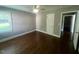 Bedroom with hardwood floors, a window, and access to the hall at 331 E Lillington St, Angier, NC 27501