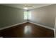 Cozy bedroom with hardwood floors, natural light, and a ceiling fan at 331 E Lillington St, Angier, NC 27501