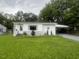 Single story home with nice grass and shrubs, with carport to the side at 331 E Lillington St, Angier, NC 27501