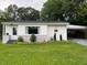 Charming single-story home with a white exterior, brick accents, and a well-manicured front lawn at 331 E Lillington St, Angier, NC 27501