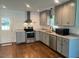 Updated kitchen featuring granite countertops, stainless steel appliances, and modern gray cabinets at 331 E Lillington St, Angier, NC 27501