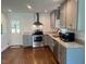 Renovated kitchen featuring ample granite counters, stainless steel appliances, and hardwood flooring at 331 E Lillington St, Angier, NC 27501