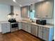 Modern kitchen featuring stainless steel appliances, granite countertops, and gray cabinetry at 331 E Lillington St, Angier, NC 27501