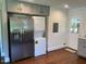 Clean kitchen features stainless steel fridge and washer/dryer combo for ease of living at 331 E Lillington St, Angier, NC 27501