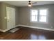 Bright living room featuring hardwood floors, large windows, and a ceiling fan at 331 E Lillington St, Angier, NC 27501