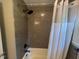 Bathroom shower with gray brick tiles and a shower curtain at 331 E Lillington St, Angier, NC 27501
