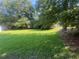 Expansive yard with mature trees offering shade and privacy, perfect for outdoor activities at 331 E Lillington St, Angier, NC 27501