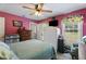 Pink bedroom with bed, ceiling fan, wardrobe, and windows offering natural light at 3573 Northern Estates Cir, Rocky Mount, NC 27804