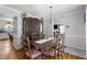 Inviting dining room boasts a large wooden table, hutch, and decorative chandelier at 3573 Northern Estates Cir, Rocky Mount, NC 27804
