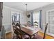 Charming dining room features hardwood floors, a chandelier, and vintage-style furniture at 3573 Northern Estates Cir, Rocky Mount, NC 27804