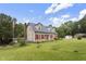 Charming home featuring red shutters, a well-manicured lawn, an American flag, and a chimney at 3573 Northern Estates Cir, Rocky Mount, NC 27804